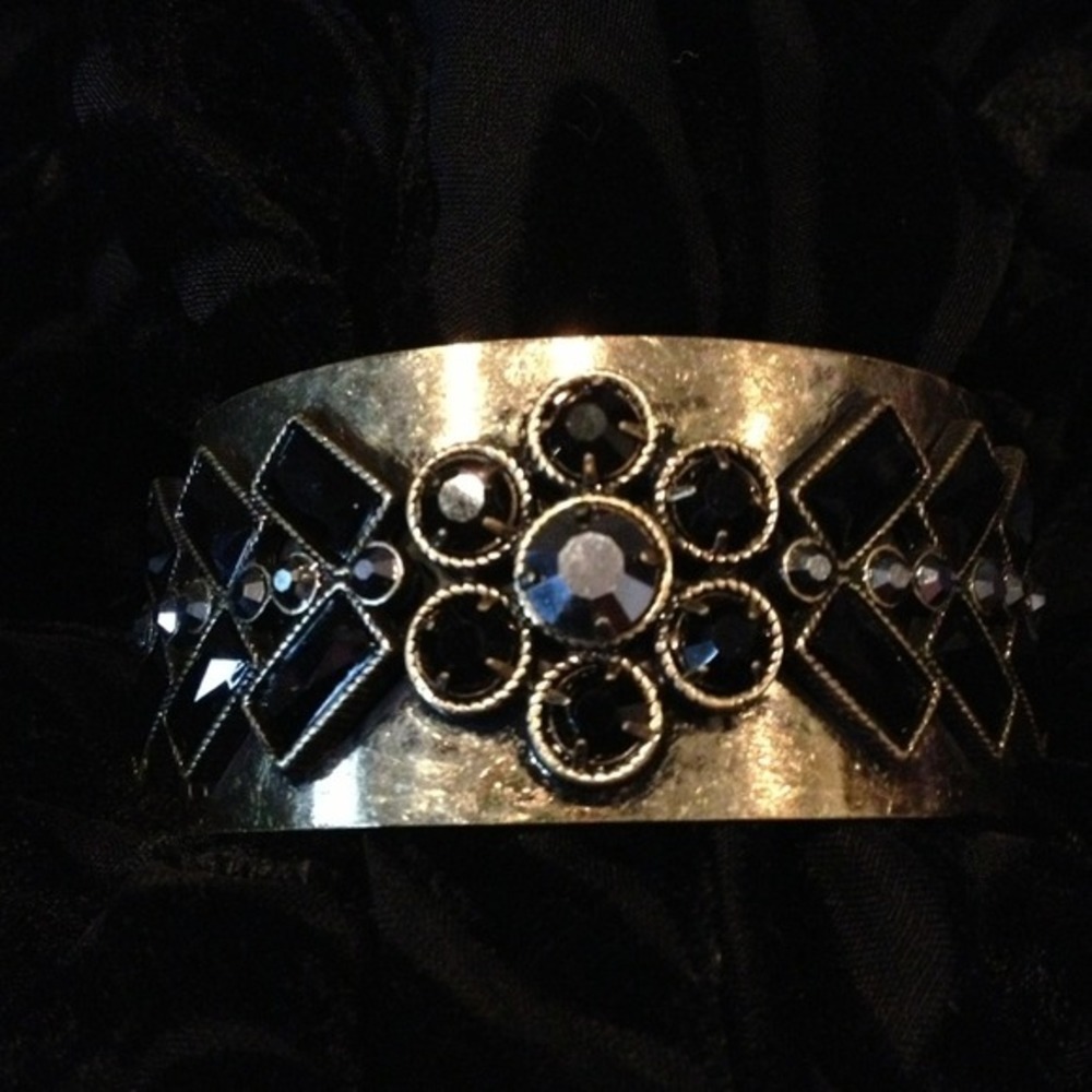 Golden bracelet with black stones